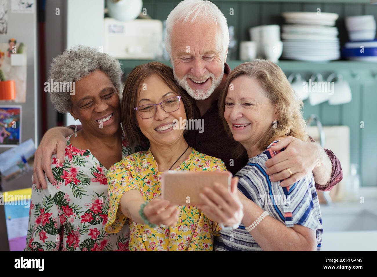 Active senior friends taking selfie with camera phone Stock Photo