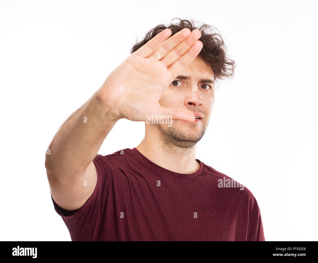 Young man covering his eyes by hands Stock Photo