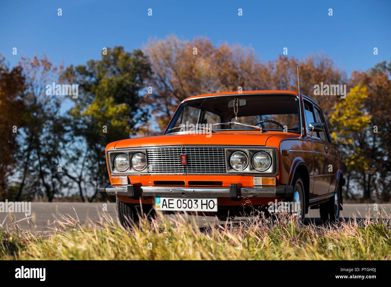 PERESHCHEPINO, UKRAINE - OCTOBER 12, 2014: Zhiguli VAZ 2106 original orange, released in the USSR in 70's. Car parked on the side of the road in the m Stock Photo