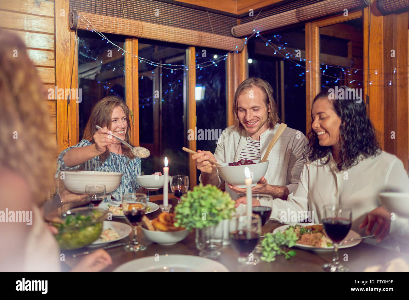 Friends enjoying dinner in cabin Stock Photo