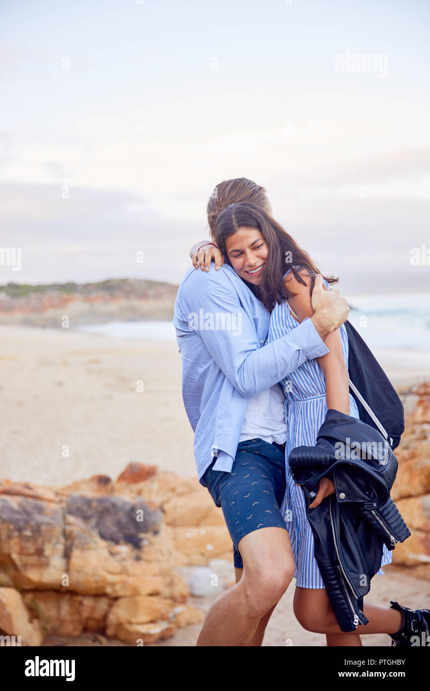 Affectionate couple hugging at beach Stock Photo
