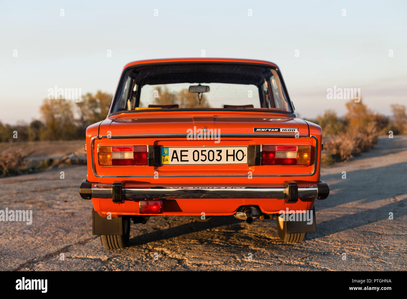 PERESHCHEPINO, UKRAINE - OCTOBER 12, 2014: Zhiguli VAZ 2106 original orange, released in the USSR in 70's. Car parked on the side of the road in the m Stock Photo
