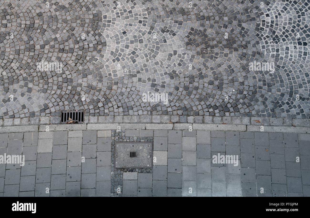 Cobblestones and sidewalk seen from above. Stock Photo