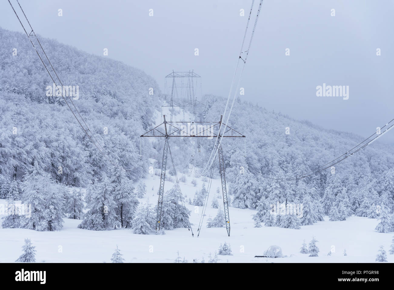 Electricity pylons in winter mountains in Bulgaria Stock Photo - Alamy