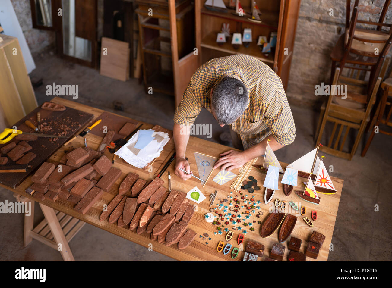A joiner is sketching a model in his workshop Stock Photo