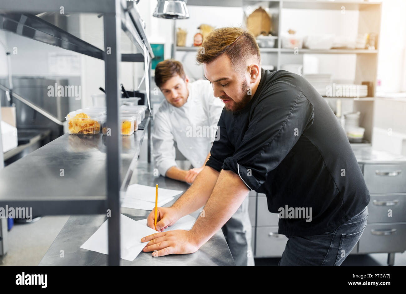 chef and cook with grocery list at kitchen Stock Photo Alamy