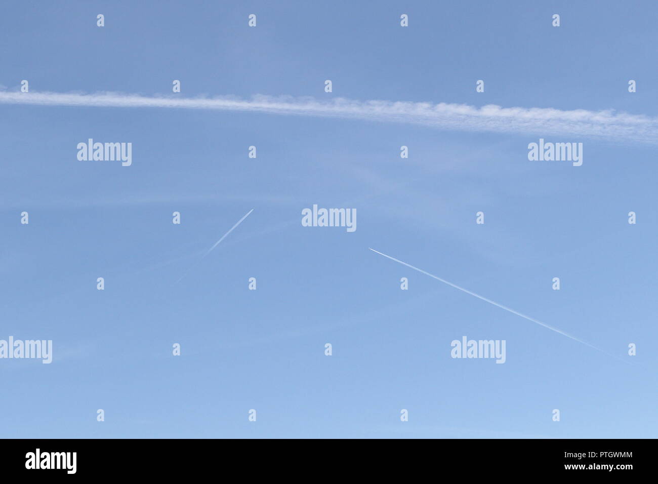 Collision course. Jet fuel vapors on the blue sky background Stock Photo