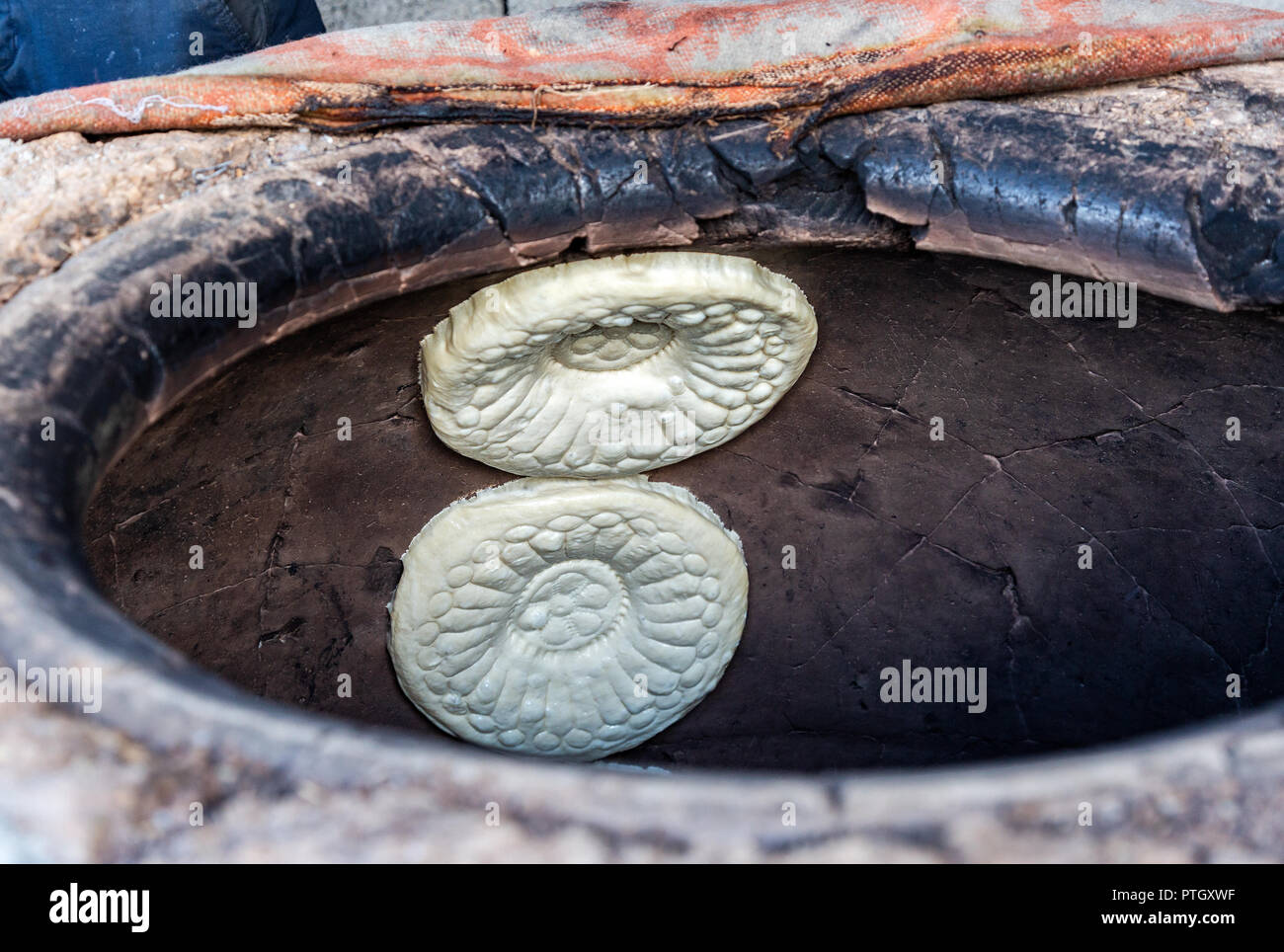 Traditional Uzbek flatbread baking in the tandyr oven Stock Photo Alamy