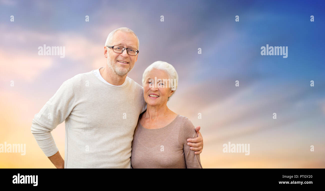 happy senior couple hugging over evening sky Stock Photo - Alamy