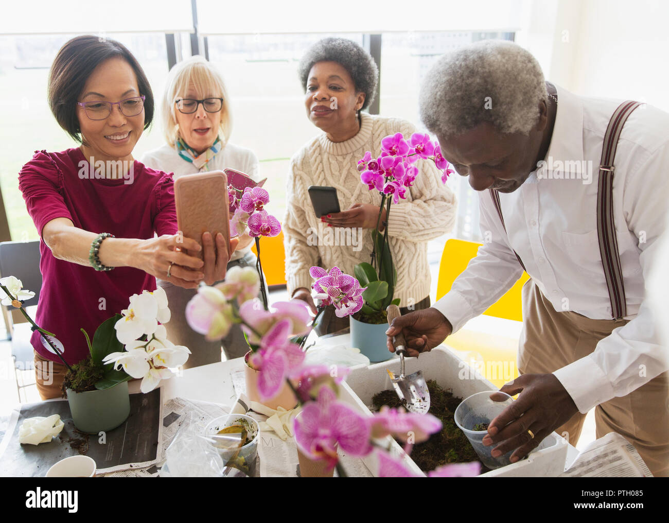Active seniors enjoying flower arranging class Stock Photo