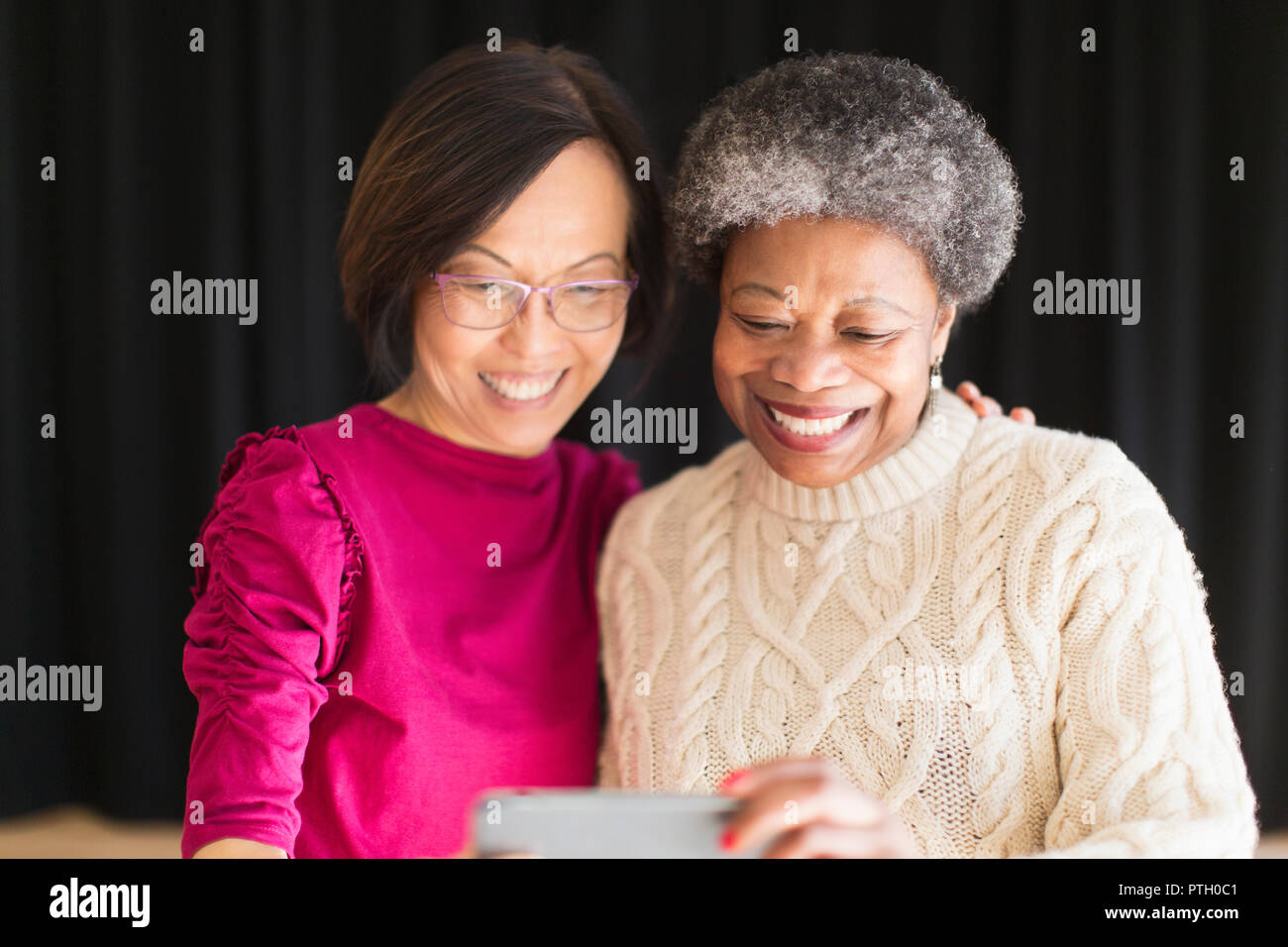 Smiling active senior women taking selfie with camera phone Stock Photo