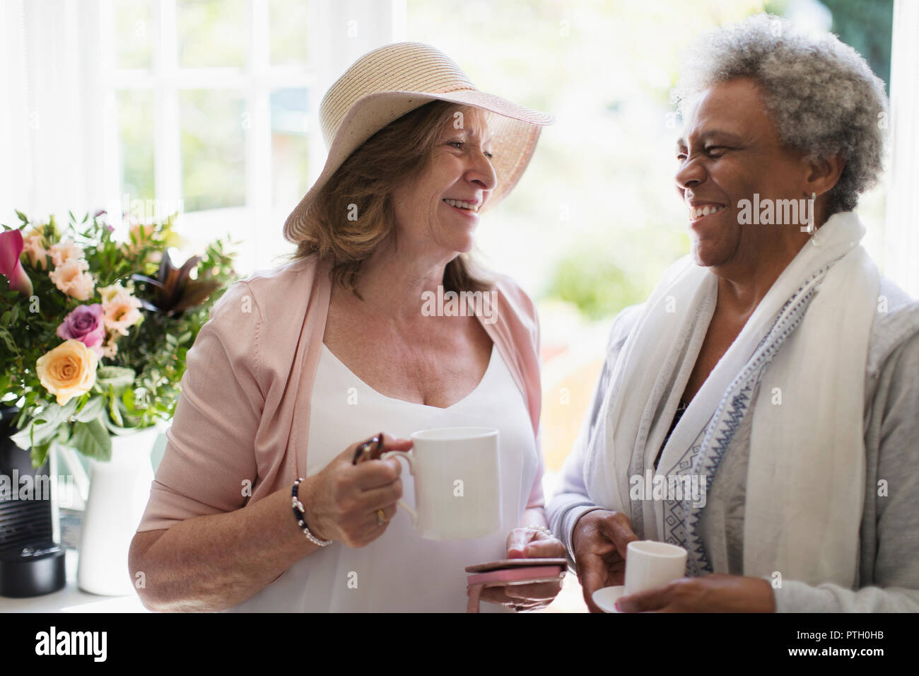 Happy senior women friends enjoying coffee Stock Photo