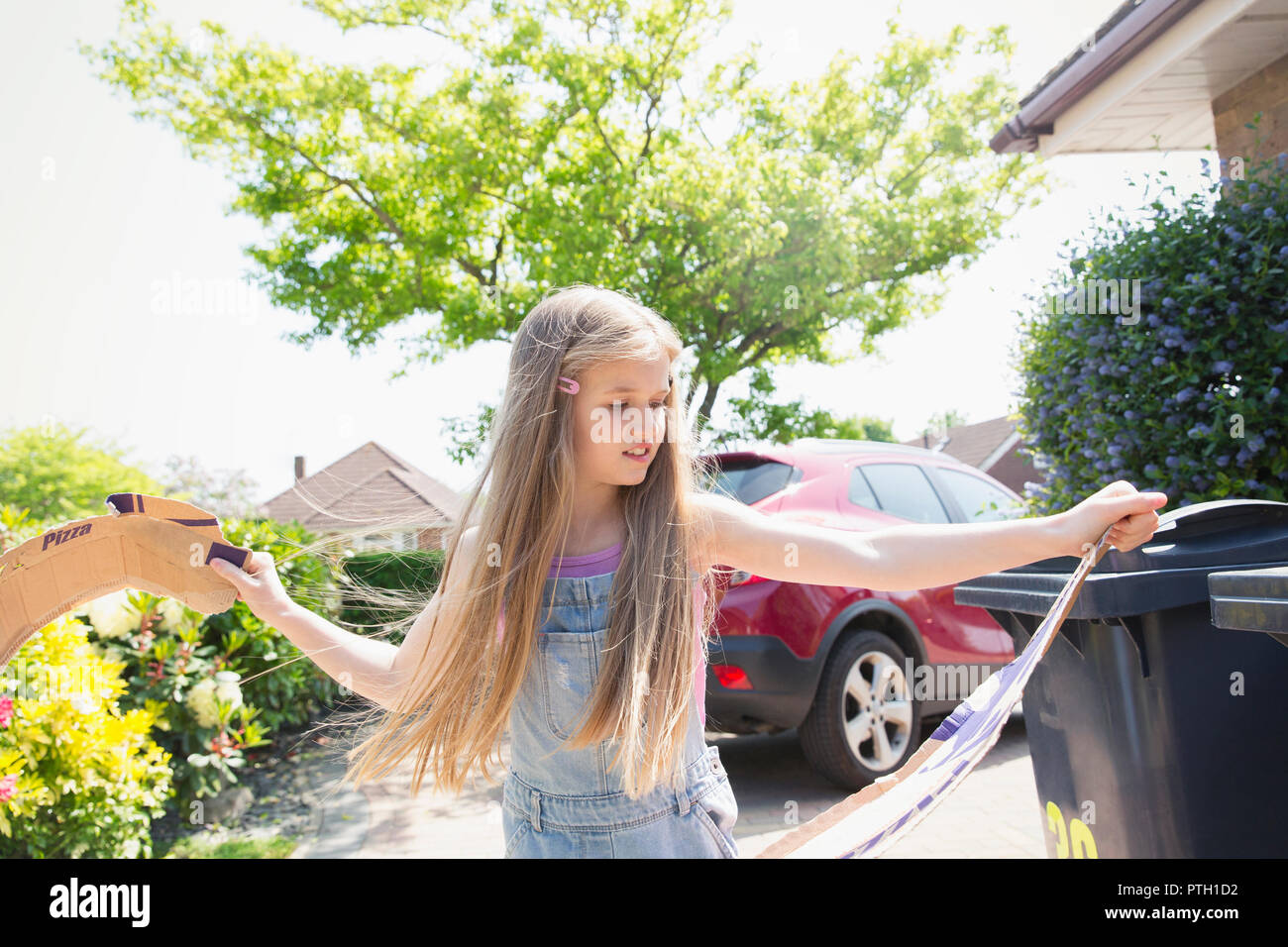 Girl recycling in driveway Stock Photo