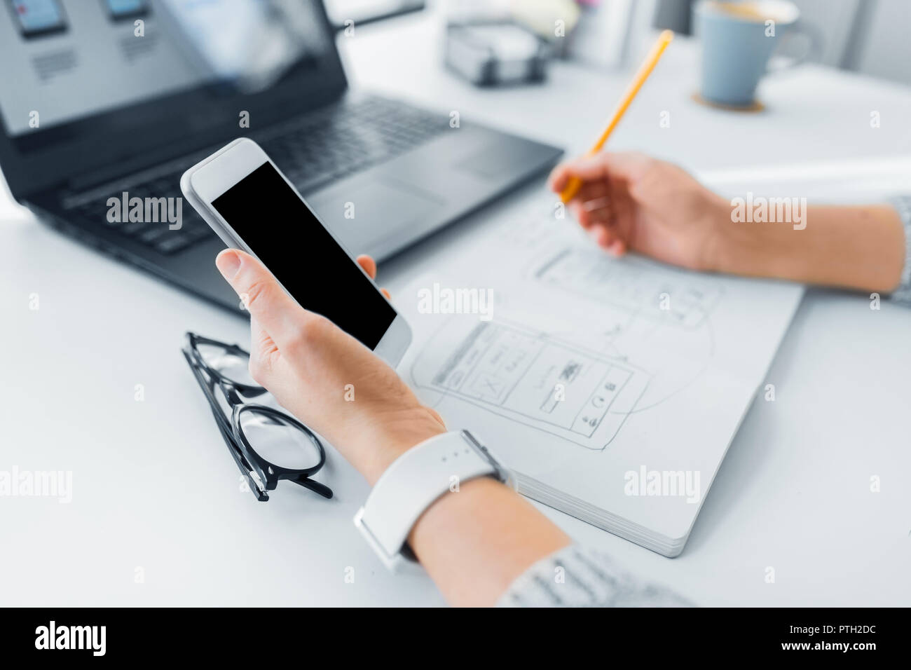 web designer working on smartphone user interface Stock Photo