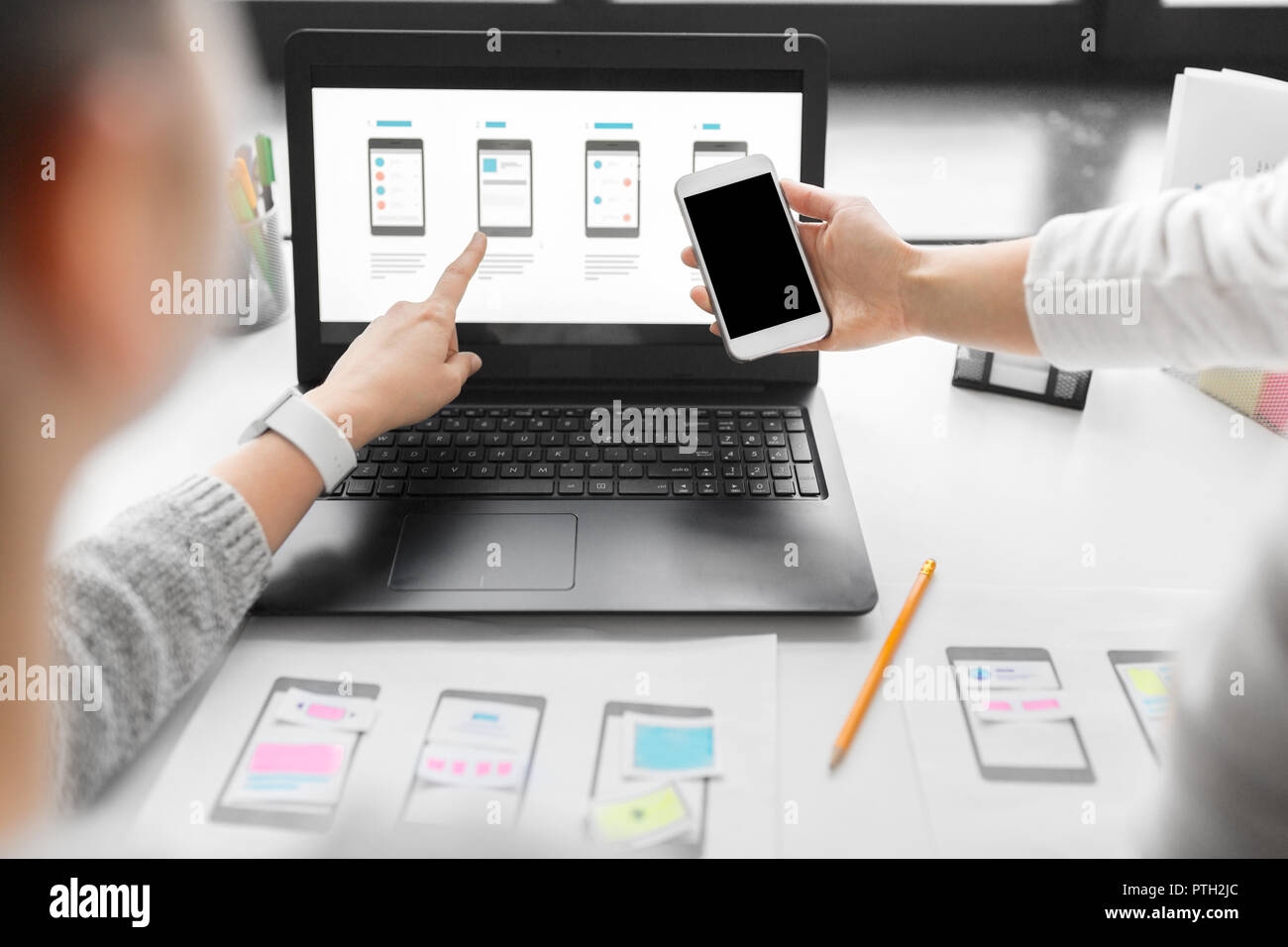 web designers work on smartphone user interface Stock Photo