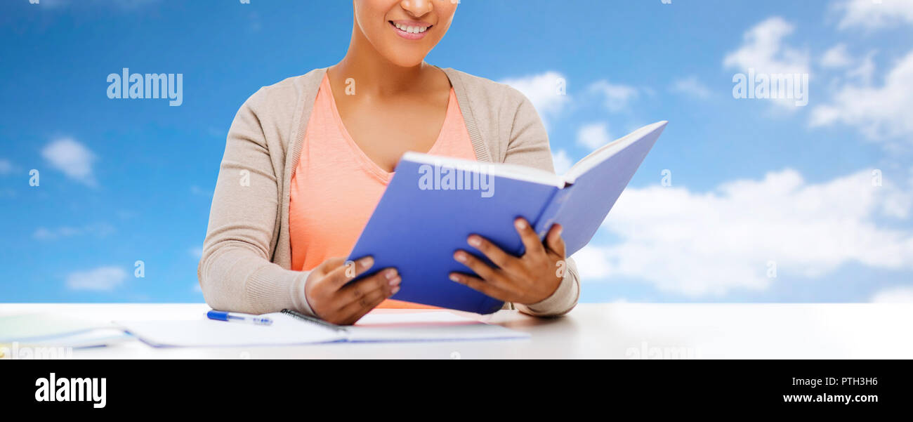 close up of african student girl reading textbook Stock Photo - Alamy