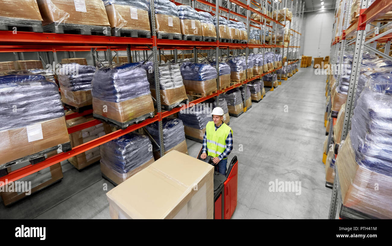 loader operating forklift at warehouse Stock Photo