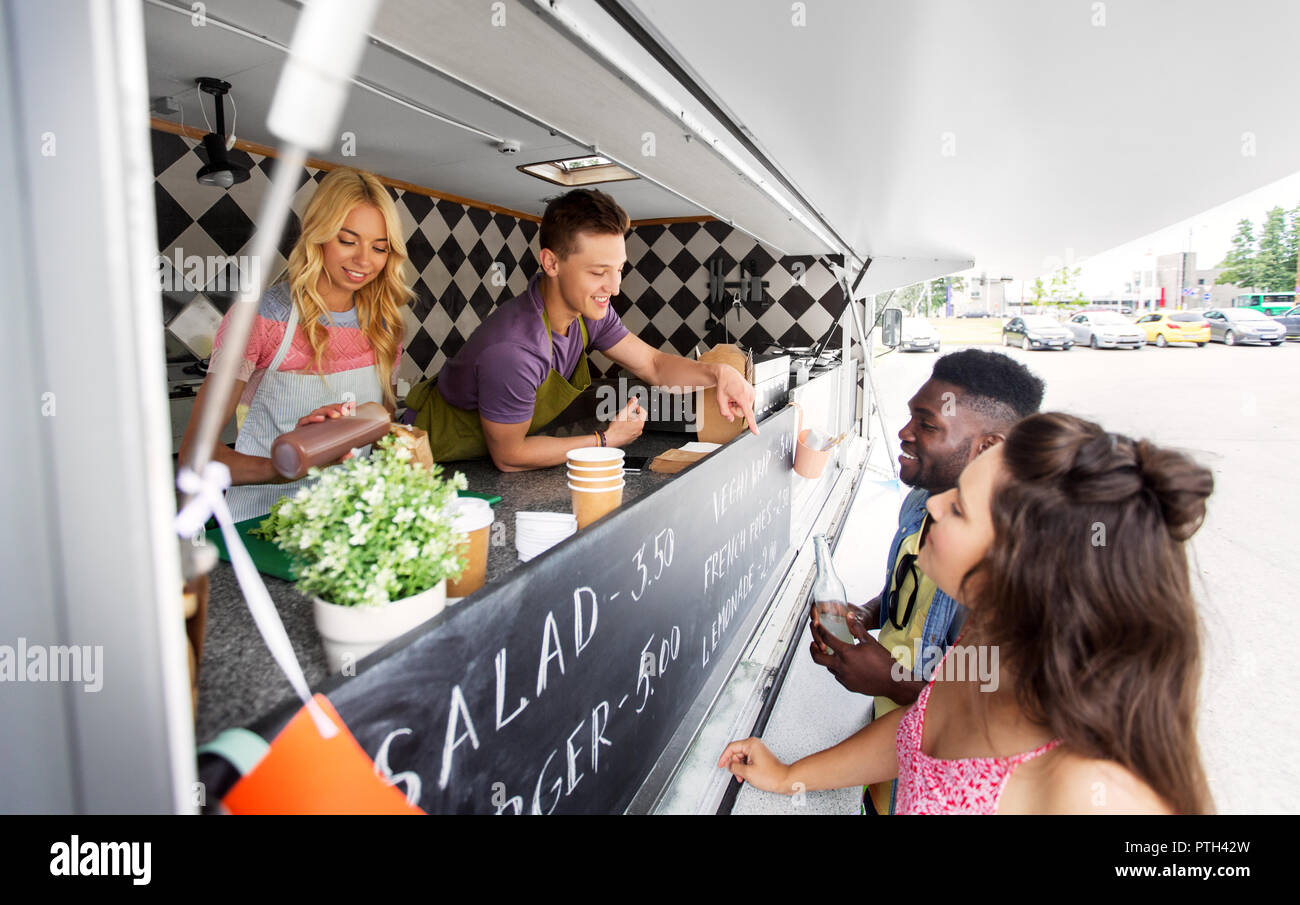 customers and seller pointing at food truck menu Stock Photo