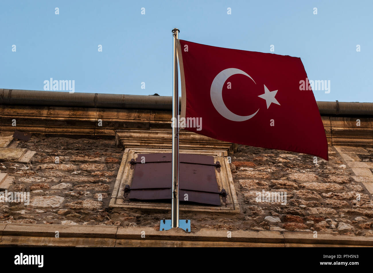 Bosnia and Herzegovina: the waving red flag of Turkey on the building of the Turkish Consulate General in the old city of Mostar Stock Photo