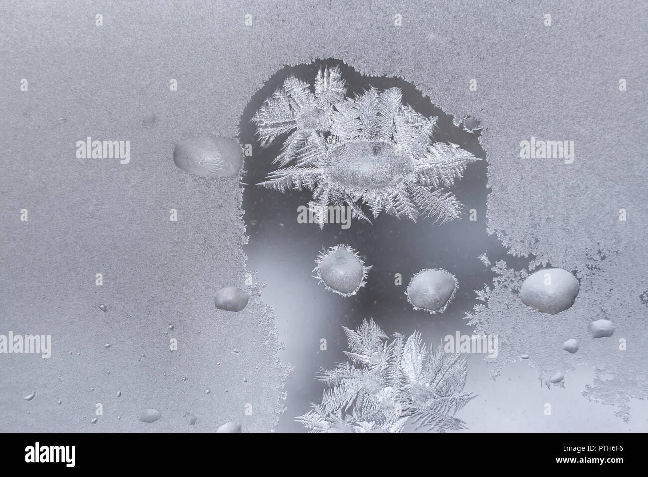 Frozen winter window with big frozen water drops and icy crystal ...