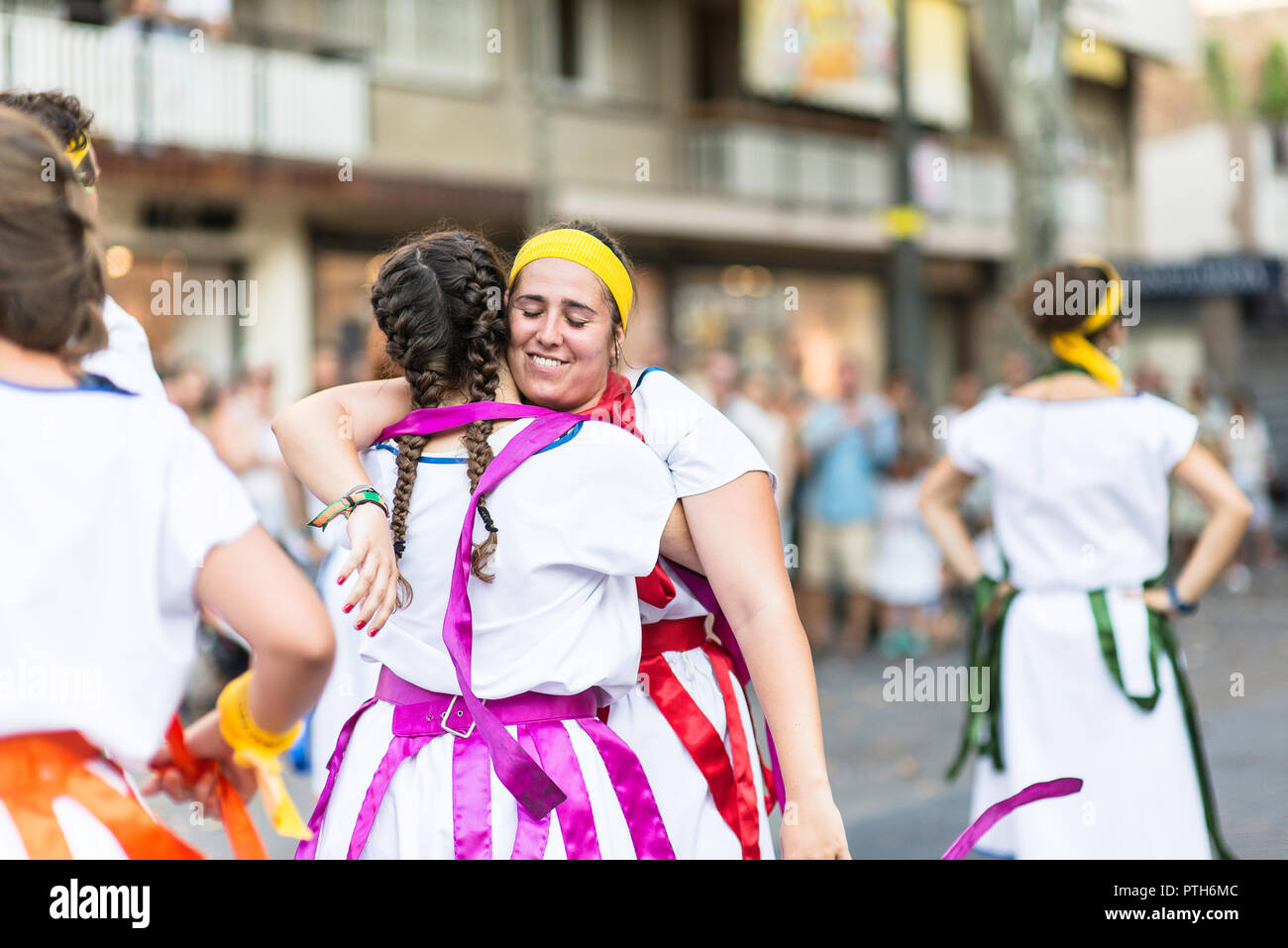 Girls hugging each others after their performance at the Feta Major in Vilanova i la Geltru, Barcelona. Summer 2018 Stock Photo