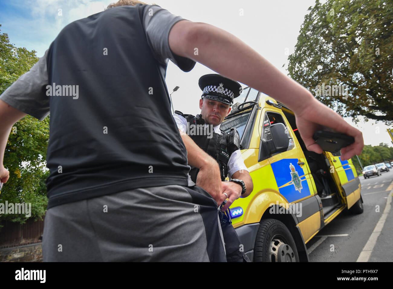 Merseyside Police constable Barry Blackmore carries out a Stop and Search in the Bootle area of Liverpool Stock Photo