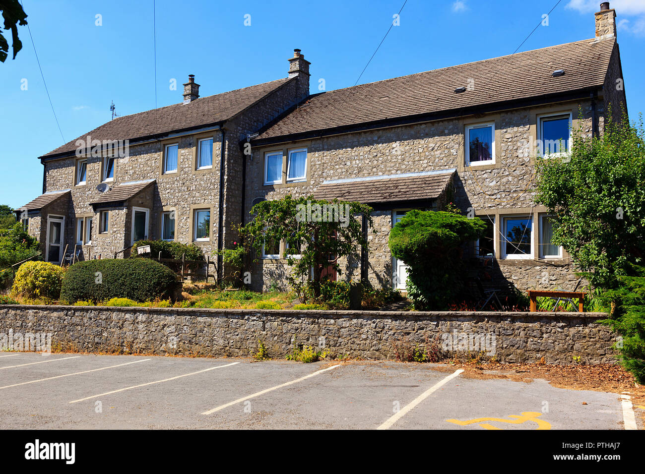 Terraced Stone Houses overlooking car park in Over Haddon Derbyshire