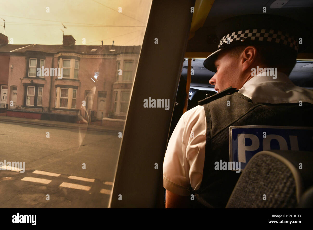Superintendent Matt Boyle looks out of a patrol van window as Merseyside Police officers carry out Stop and Searches in the Bootle area of Liverpool   Stock Photo