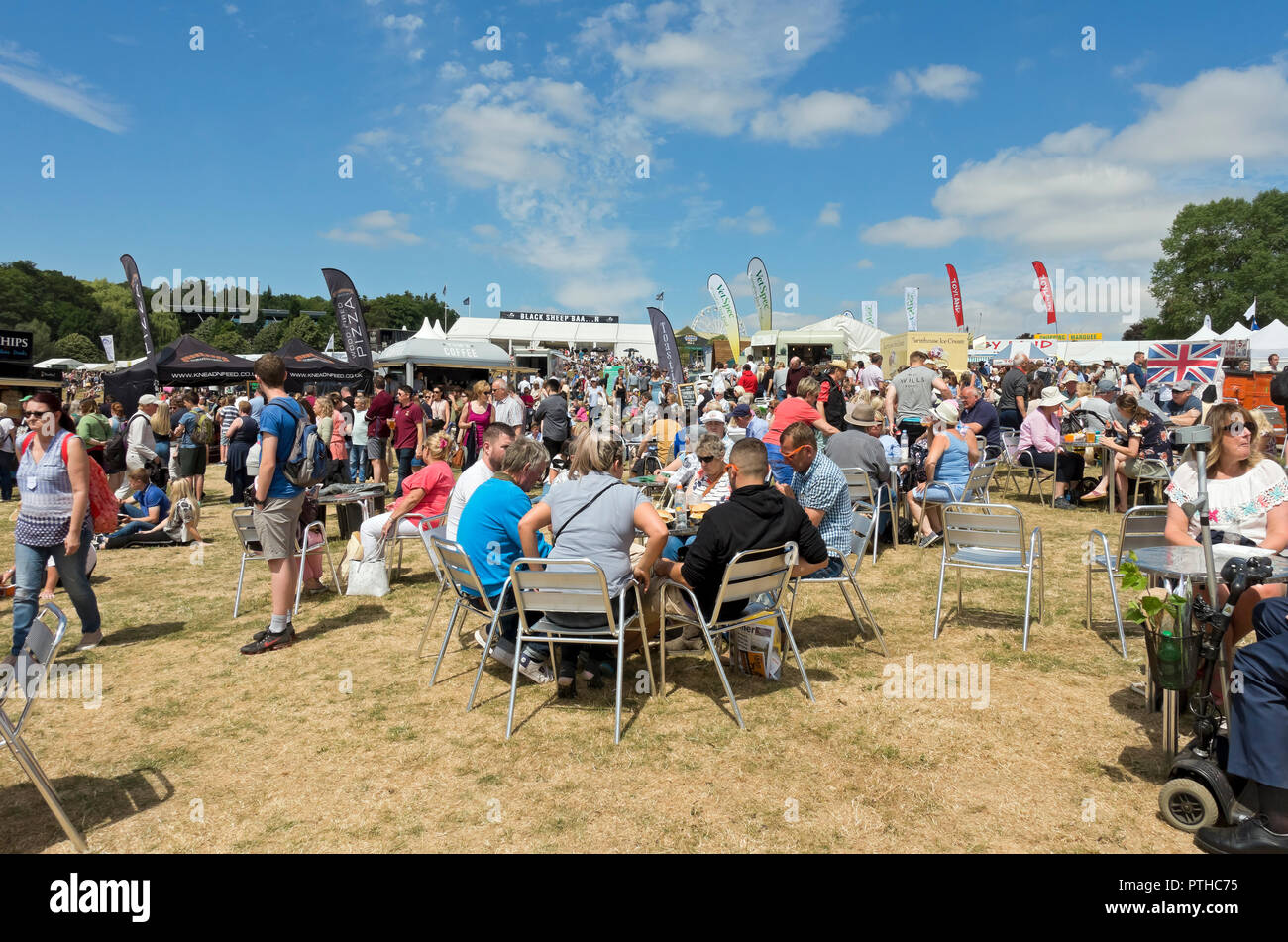 People eating and sitting sat outside at the Great Yorkshire Show in summer Harrogate North Yorkshire England UK United Kingdom GB Great Britain Stock Photo