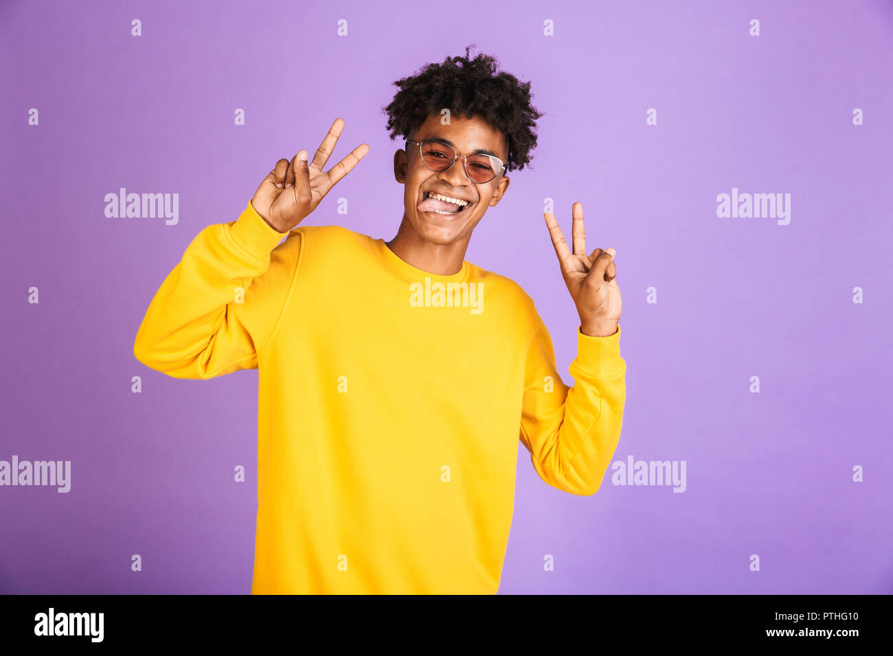 Portrait of a funny young afro american man in sweatshirt isolated, showing peace Stock Photo