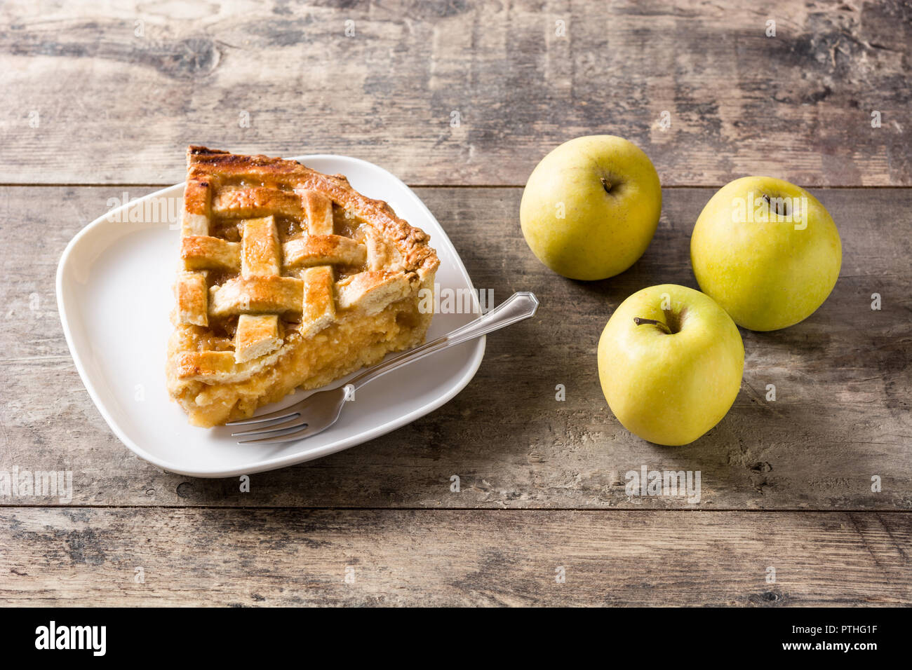 Homemade apple pie slice on wooden table Stock Photo