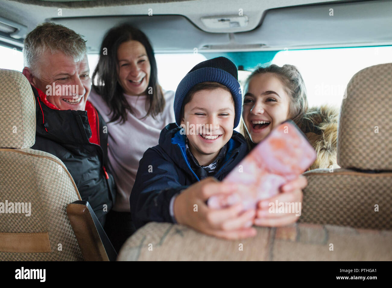 Happy family with smart phone in motor home Stock Photo