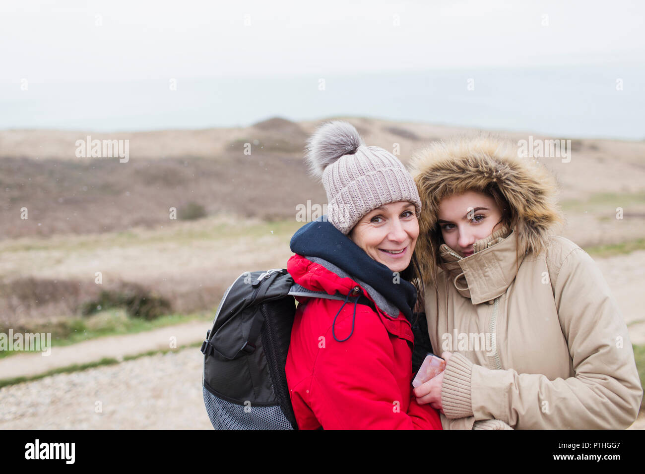 Portrait smiling mother and daughter in warm clothing Stock Photo
