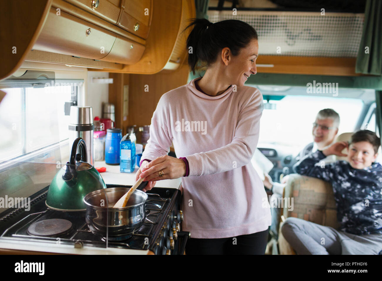 Mother cooking for family in motor home Stock Photo