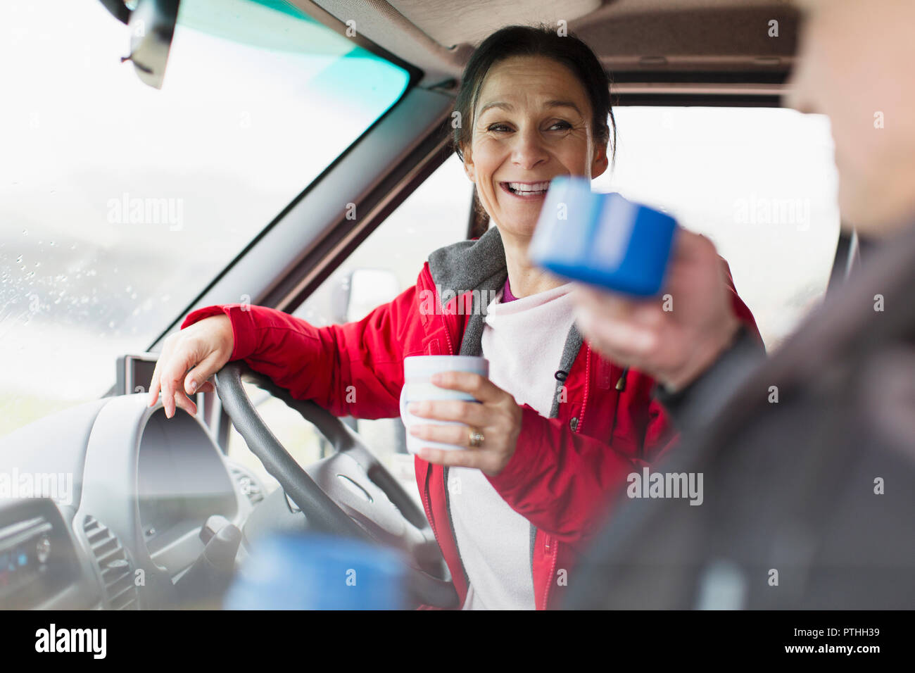 Couple drinking coffee in motor home Stock Photo