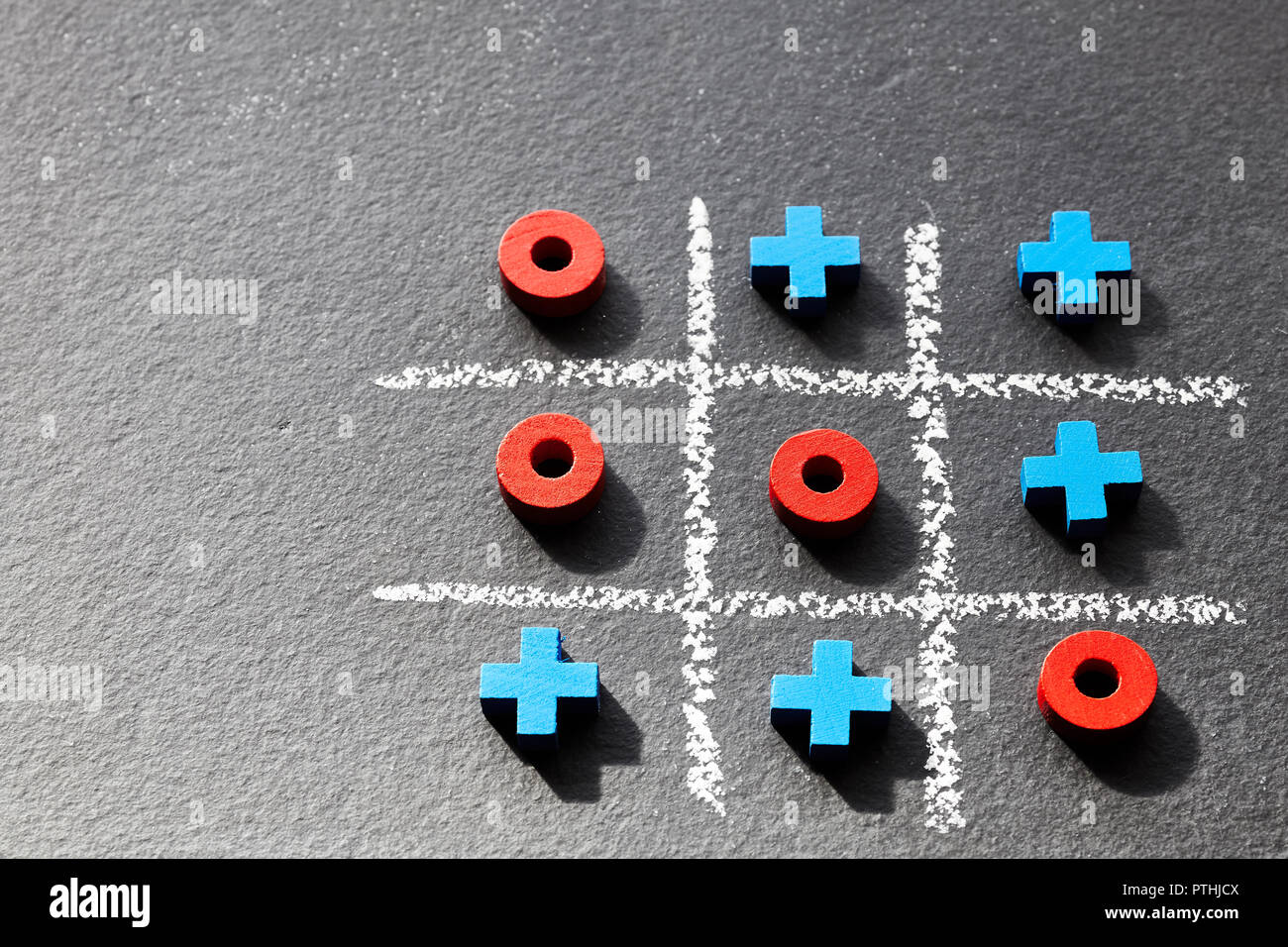 Close up picture of tic tac toe game (noughts and crosses) on dark  background, selective focus Stock Photo - Alamy