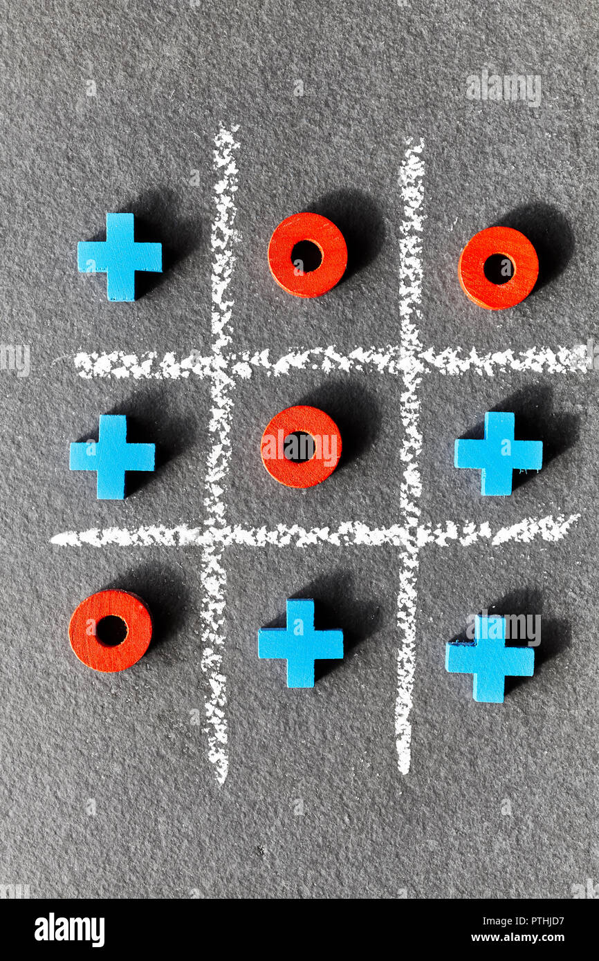Close up picture of tic tac toe game (noughts and crosses) on dark background, selective focus. Stock Photo