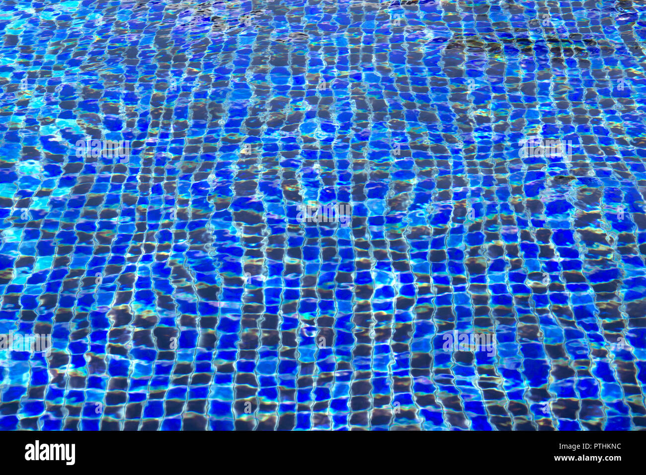 Ripple and flow with waves swimming pool bottom background. Stock Photo