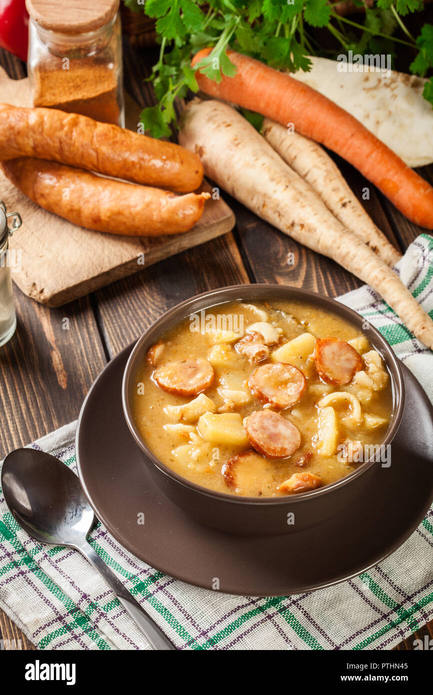Traditional Polish split pea soup with sausage, bacon and potatoes in