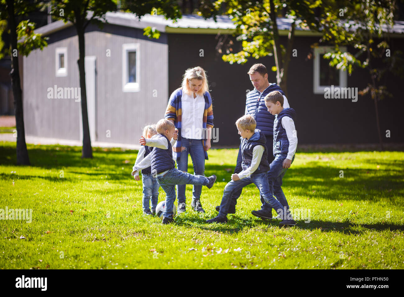 family outdoor activities enjoying the theme family outdoor activities big friendly caucasian of six mom dad and four children playing football running with the ball on lawn family outdoor activities enjoying the theme family outdoor activities big friendly caucasian of six mom dad and four children playing football running with the ball on lawn