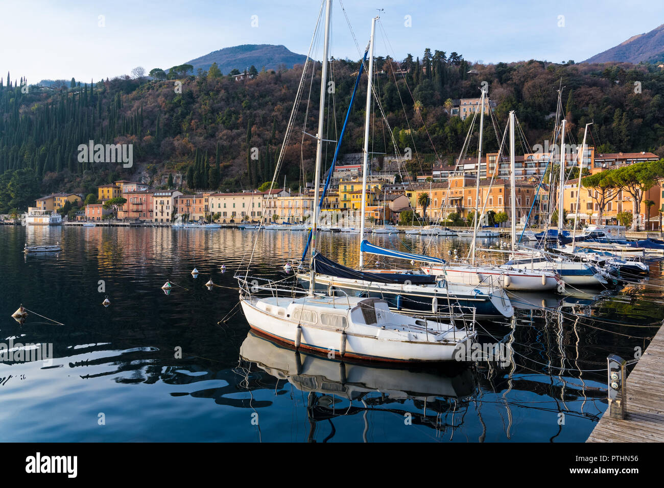 Various boats at the lake Garda, as seen from the coast of the town of Toscolano Maderno in Italy Stock Photo