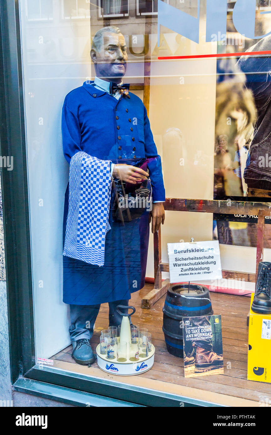 A mannequin in the uniform of a köbes (waiter) in the window display of a work clothing outfitter, Köln, Nordrhein-Westfalen, Germany Stock Photo