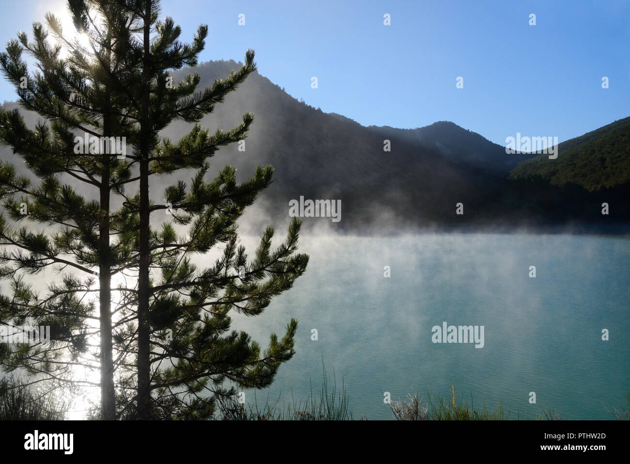 Morning Mist Rises on the Castillon Lake in the Verdon Valley Alpes-de-Haute-Provence France Stock Photo