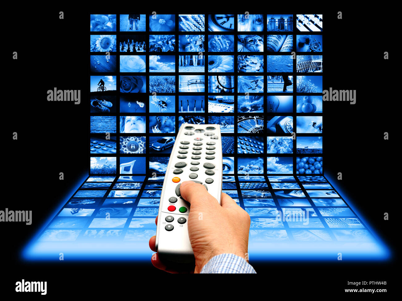man hand pointing a remote control to a screen with multiple images Stock Photo