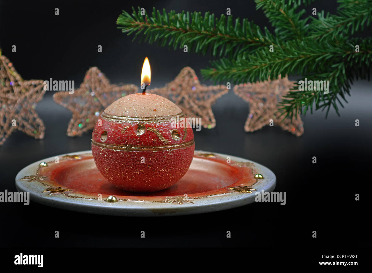 Burning candle with christmas decoration on background Stock Photo