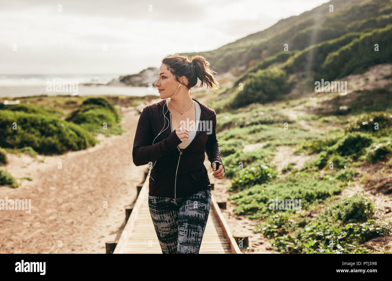 Female running outdoors in the morning. fitness woman doing running exercising outdoors. Stock Photo