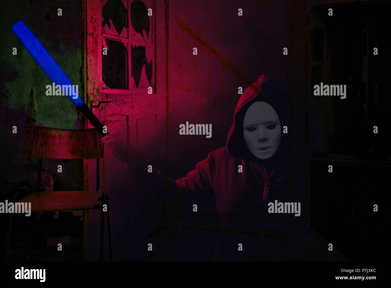 Halloween dangerous masked scary person holding a blue bat and standing