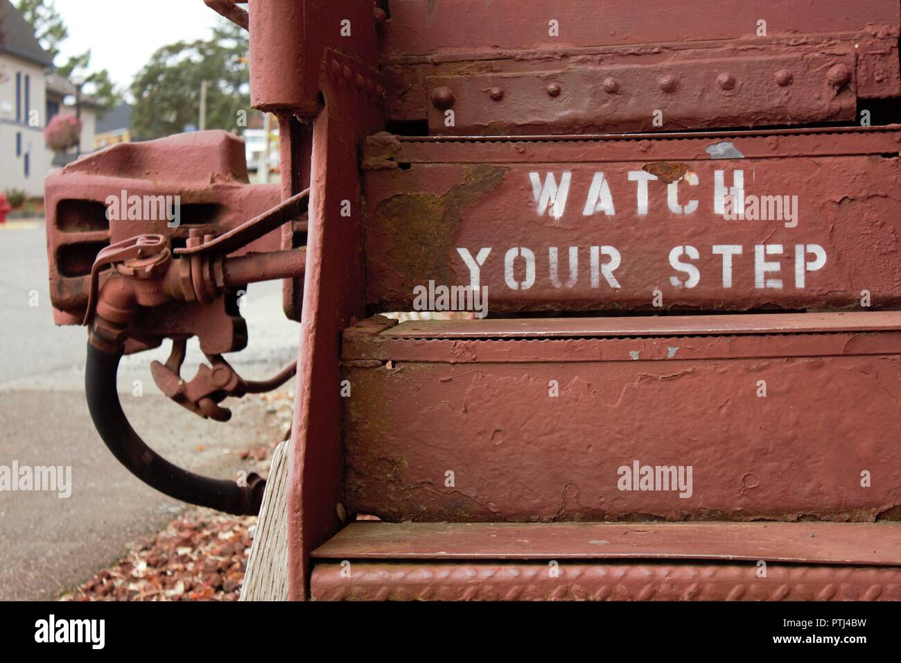Warning sign on the steps of an old caboose Stock Photo - Alamy