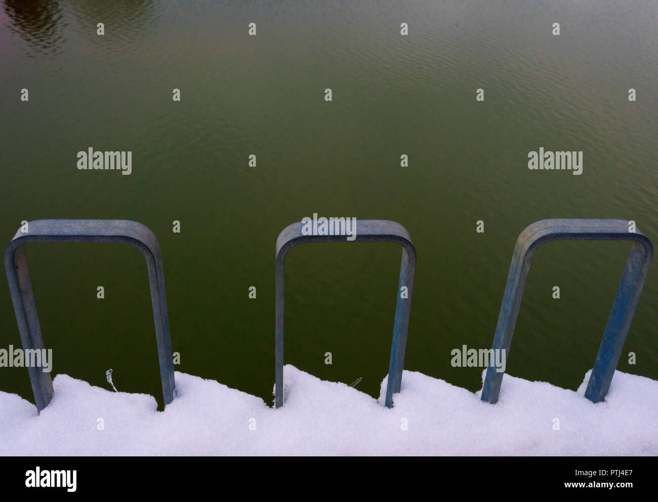 Abstract closeup image of snow covering the railing along a pier at Hagg Lake Stock Photo