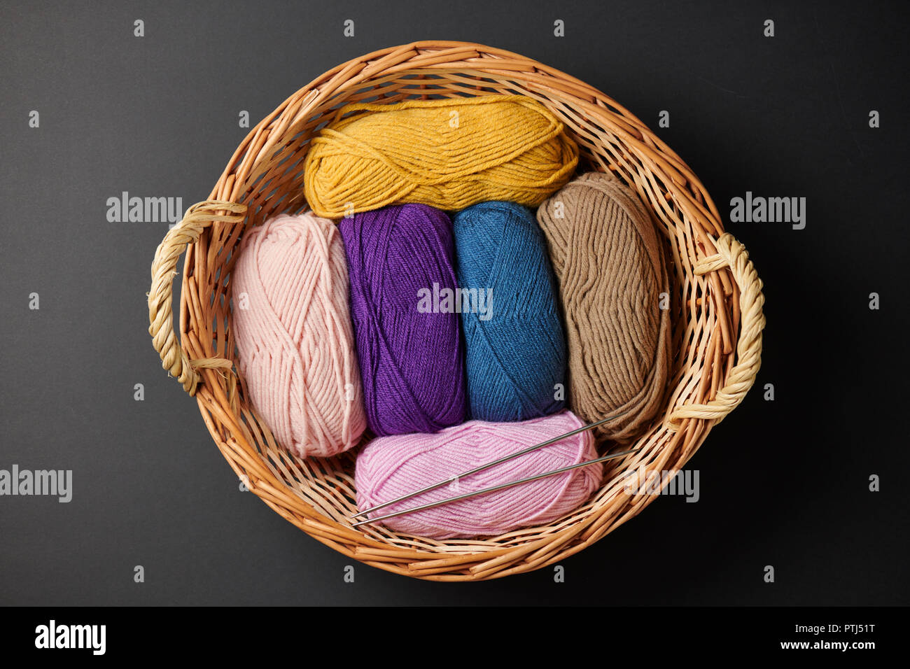 colorful wool threads for knitting on black background Stock Photo - Alamy